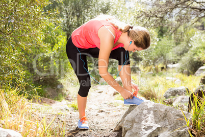 Blonde athlete tying her shoelace
