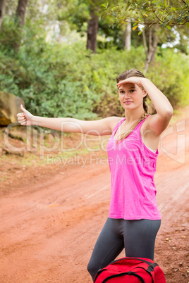 Pretty blonde with backpack hitchhiking