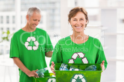 Smiling eco-minded woman holding recycling box