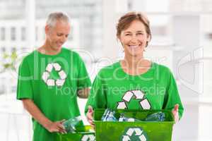 Smiling eco-minded woman holding recycling box