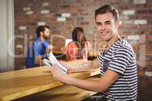 Young man reading a newspaper