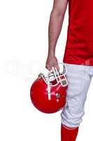 American football player holding an helmet