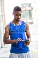 Athletic man using tablet computer