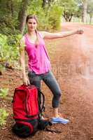 Pretty blonde with backpack hitchhiking
