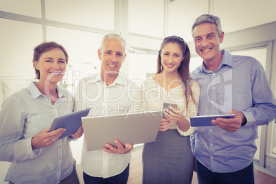 Smiling business people with electronic devices