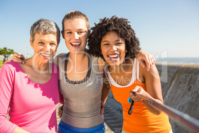 Smiling sporty women taking selfies with selfiestick