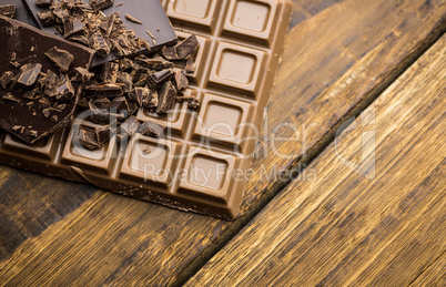 Dark and milk chocolate on a wooden table
