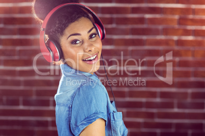 Portrait of a smiling woman listening to music
