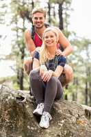 Young happy hiker couple looking at camera