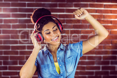 A smiling woman dancing with headphones
