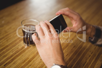 Man photographing his cup of coffee