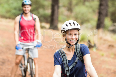 Happy young biker couple looking at camera