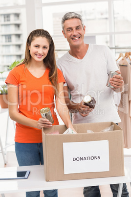 Smiling casual business colleagues sorting donations
