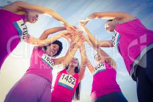 Five cheering runners supporting breast cancer marathon