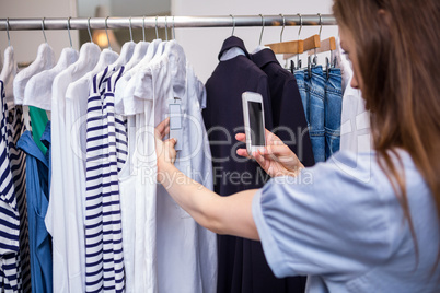 Woman taking a photo of price tag