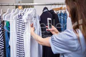 Woman taking a photo of price tag