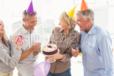 Laughing casual business people celebrating birthday