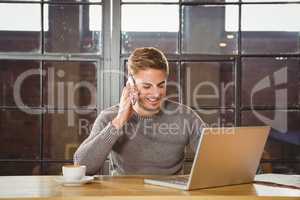 Handsome man smiling and phoning with smartphone