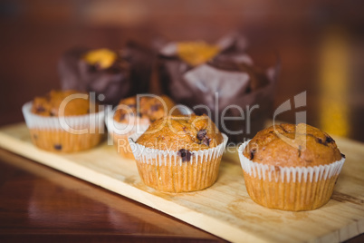 Chocolate chip muffins on cutting board