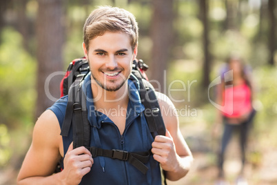 Young happy jogger looking at camera