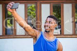 An happy handsome athlete taking a selfie