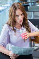 Pretty brunette sipping on a smoothie