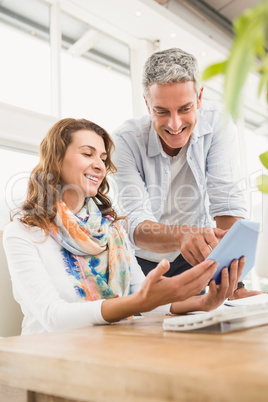 Two casual designers working with tablet