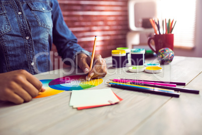 Graphic designer drawing on colour chart