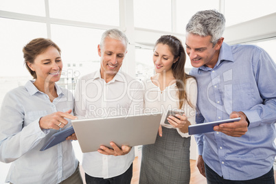 Business people using several electronic devices