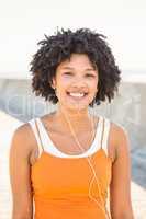 Young sporty woman enjoying music via headphones