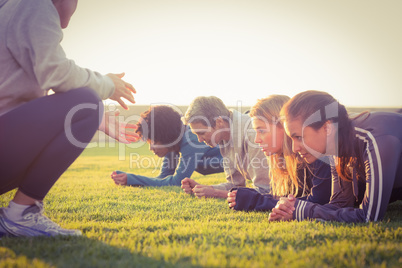 Sporty women planking during fitness class