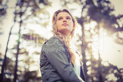 Young happy jogger sitting on rock and looking away