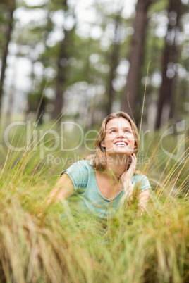 Young pretty hiker sitting in the high grass