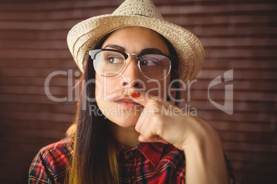 Beautiful hipster with mustache on finger
