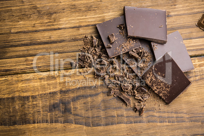 Pieces of chocolate on a wooden table