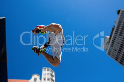 Extreme athlete jumping in the air in front of a building