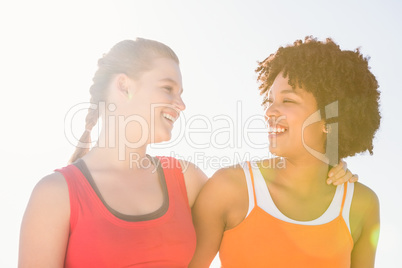 Two young women smiling at each other