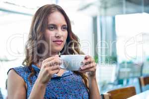 Pretty brunette enjoying a coffee