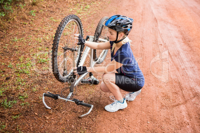 Athletic blonde checking her mountain bike