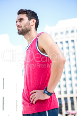 Serious handsome athlete with hands on hips