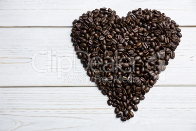 Coffee beans on a table in heart shape