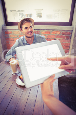 Waitress taking handsome hipsters order with tablet