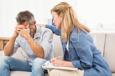 Concerned therapist comforting male patient