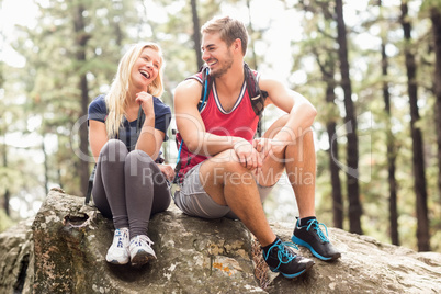 Young happy hiker couple looking at each other