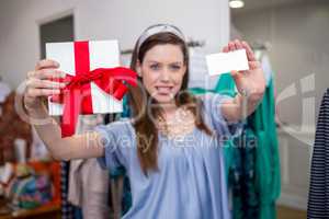 Brunette showing gift and card to camera