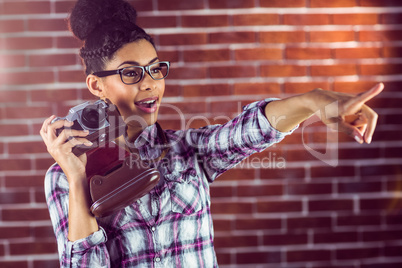 Young hipster with camera pointing