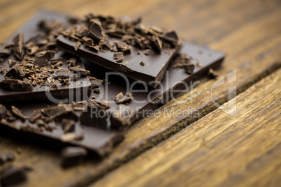 Pieces of chocolate on a wooden table