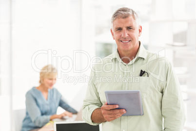 Standing smiling businessman looking at the camera