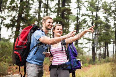 Young happy hikers pointing int he distance