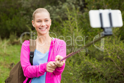 Smiling female hiker taking a selfie